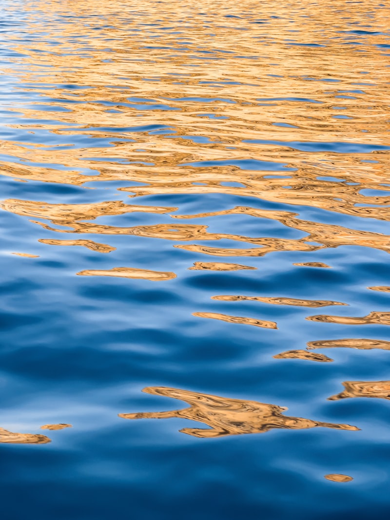 a large body of water with a boat in the distance